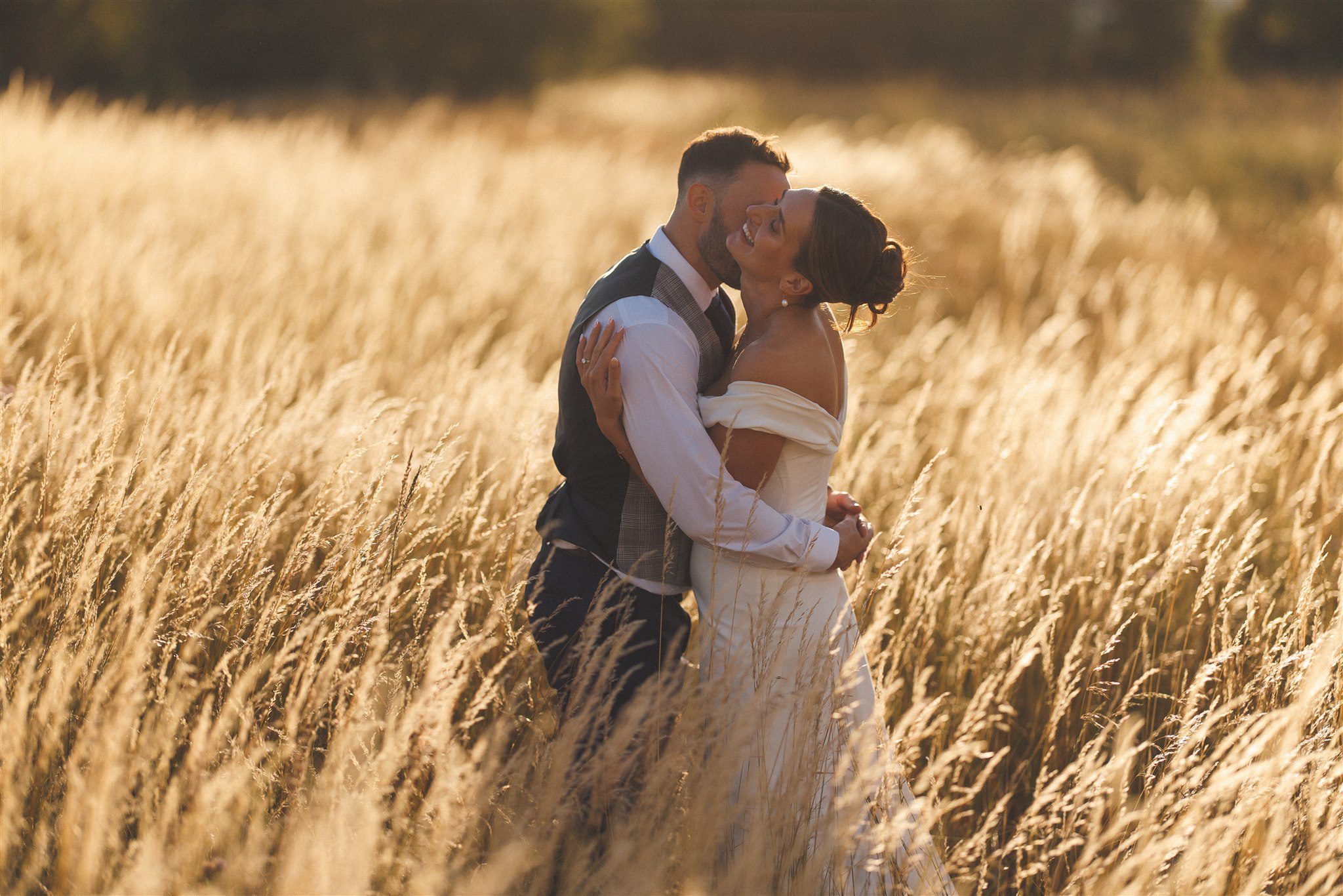 Zofia and Ben in the meadow at Elmore Court at golden hour