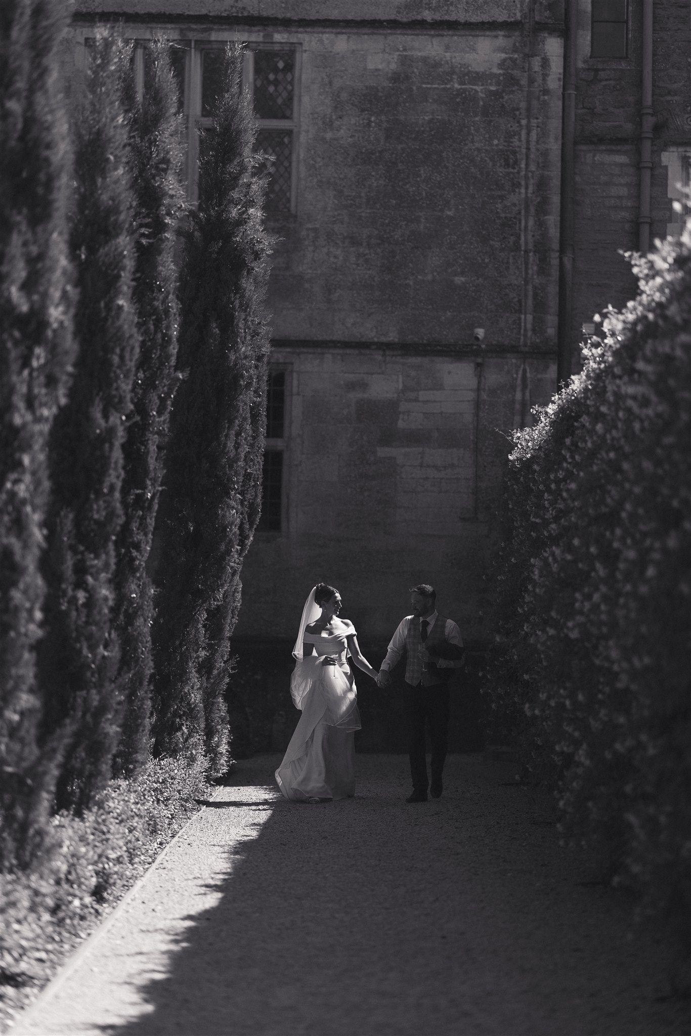 Zofia and Ben walking the hedged avenue at Elmore Court
