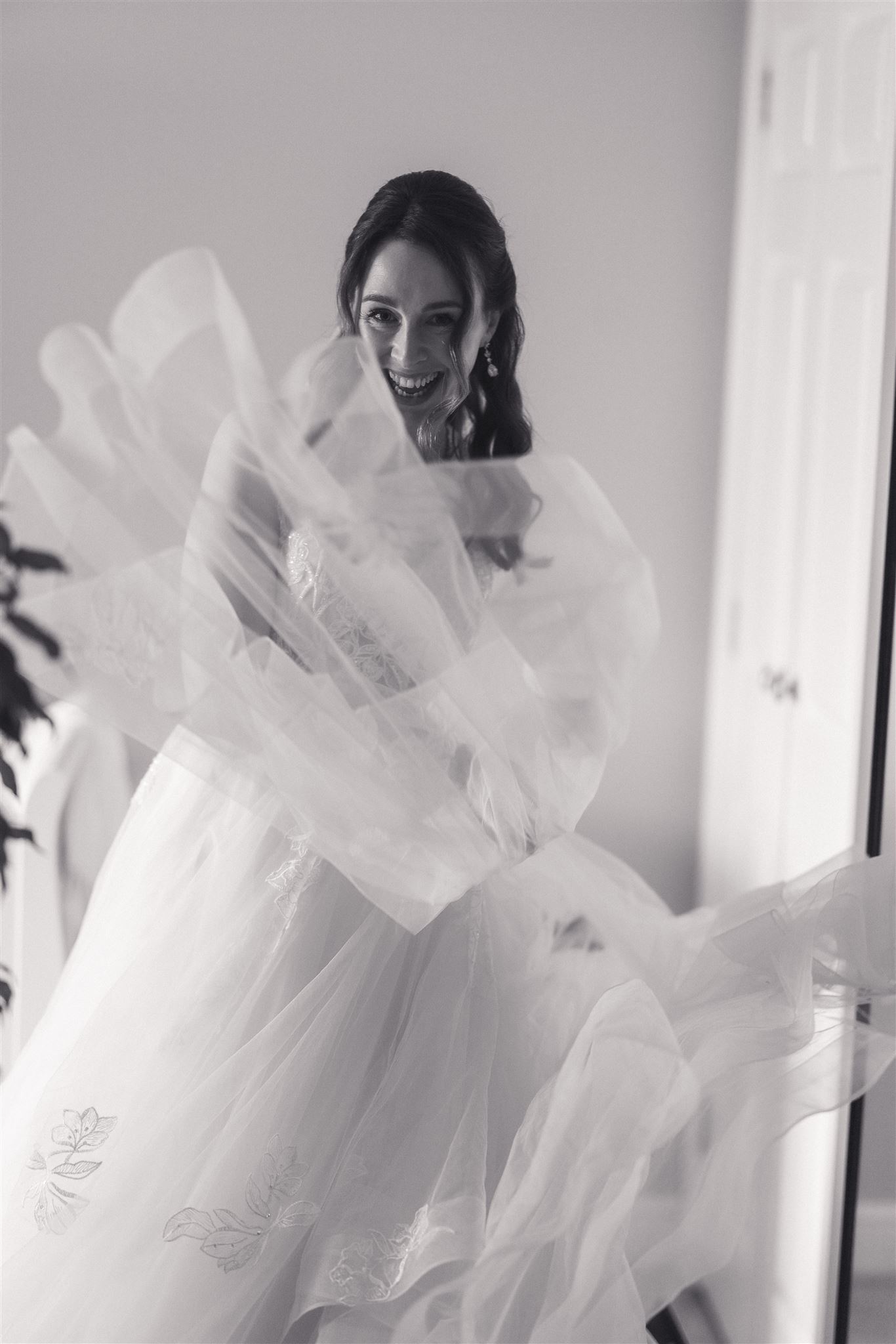 A bride in soft window light before the ceremony