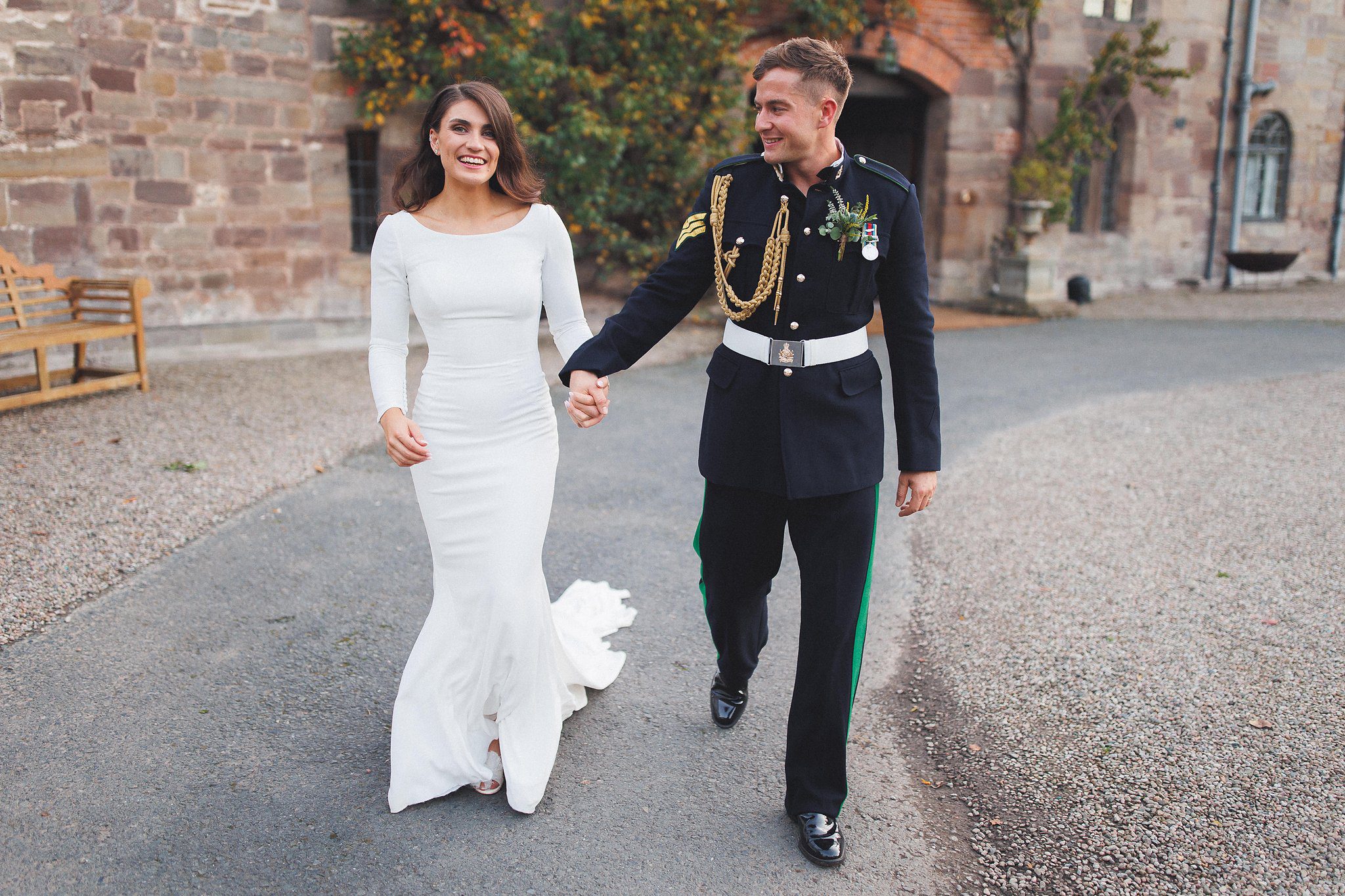 Amber and Ben walking hand in hand outside Brinsop Court