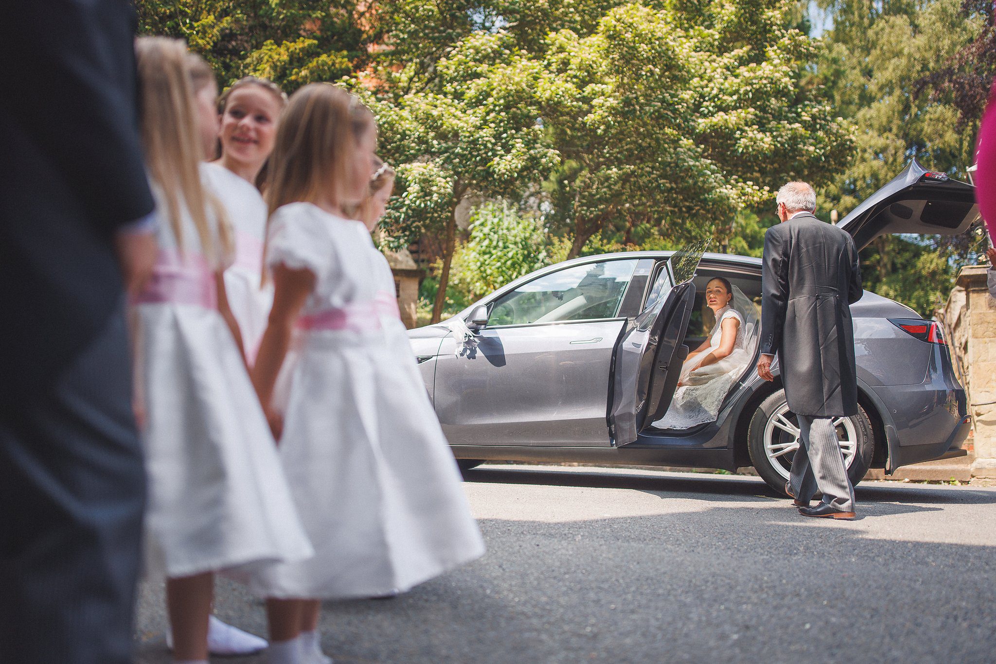 The flower girls waiting by the car