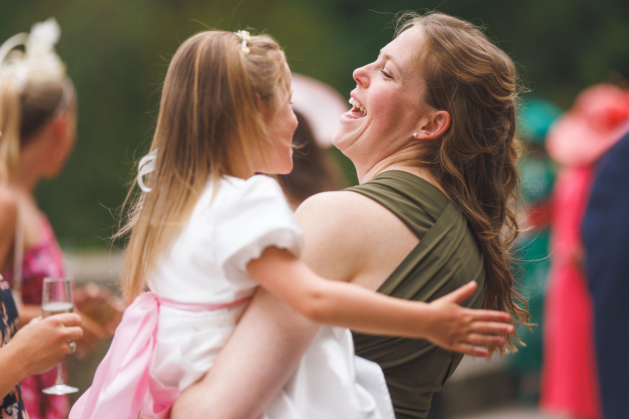 A guest lifting one of the flower girls