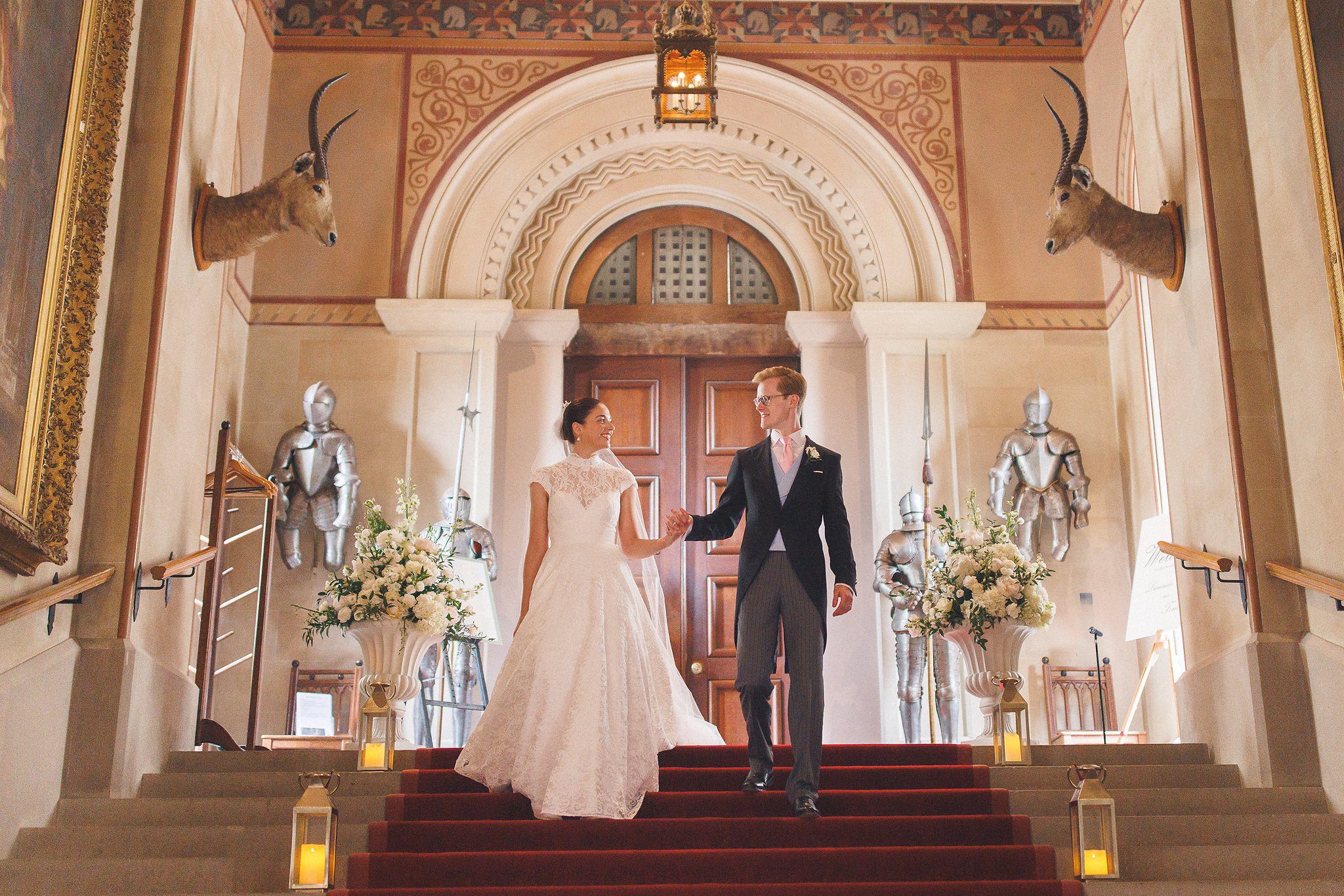 Lucinda and Tom on the stairs beneath the gothic arch