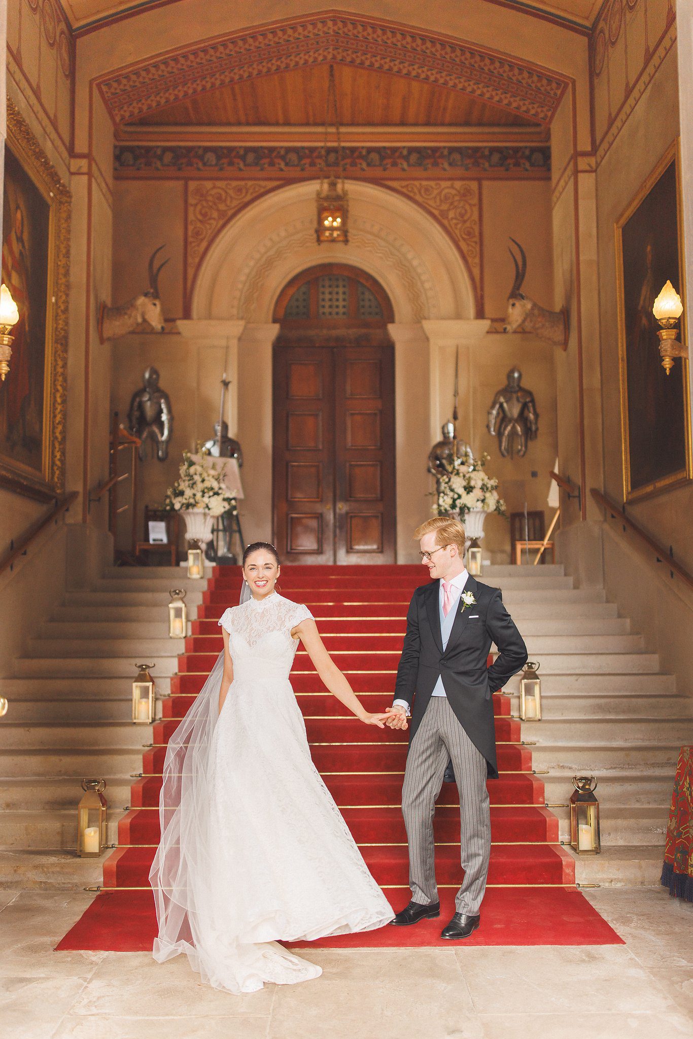 Lucinda and Tom hand in hand on the red stairs