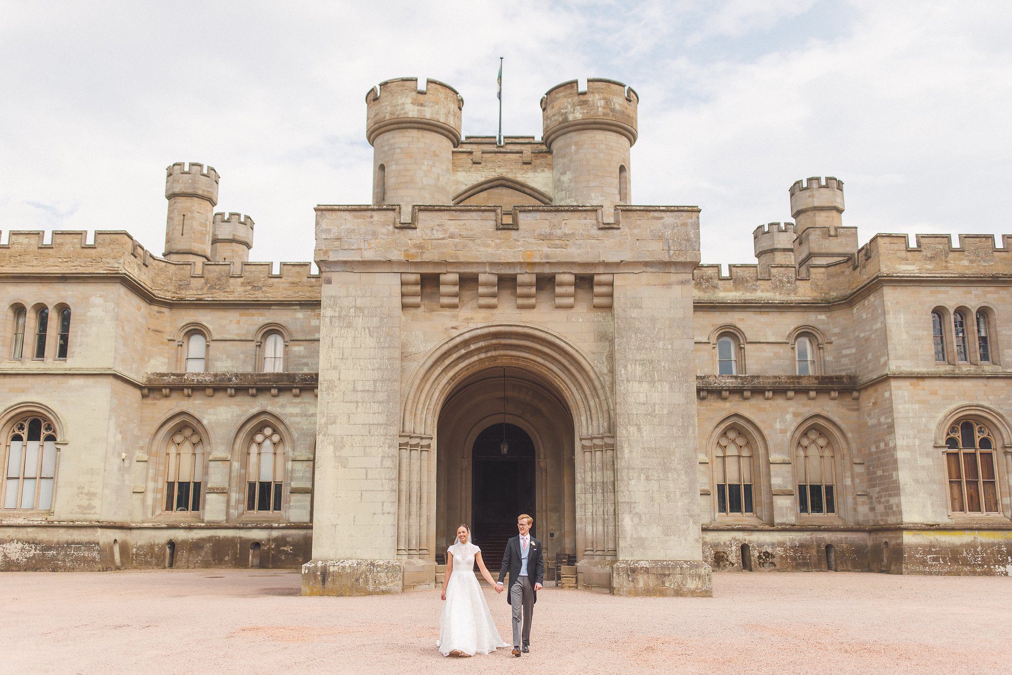 Lucinda and Tom small against the front of Eastnor Castle